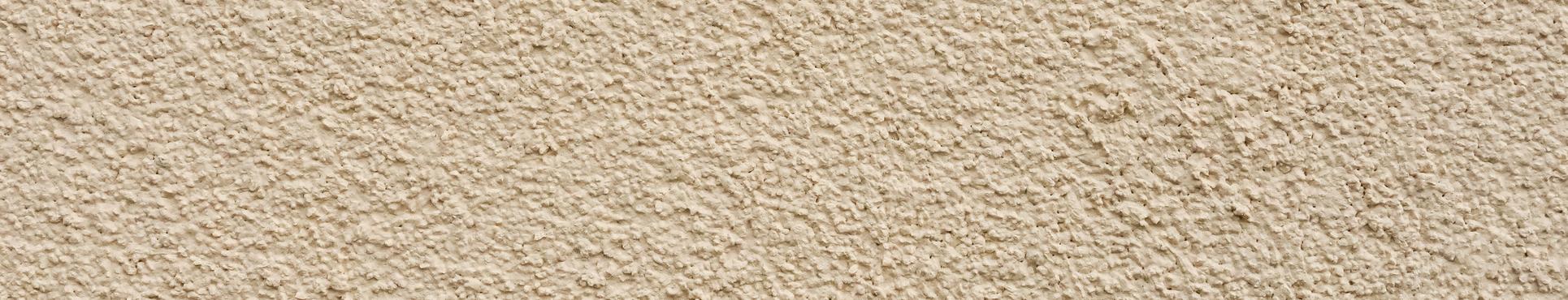 Rijhuis in Nederename met lichtgele crepi en blauwe steen